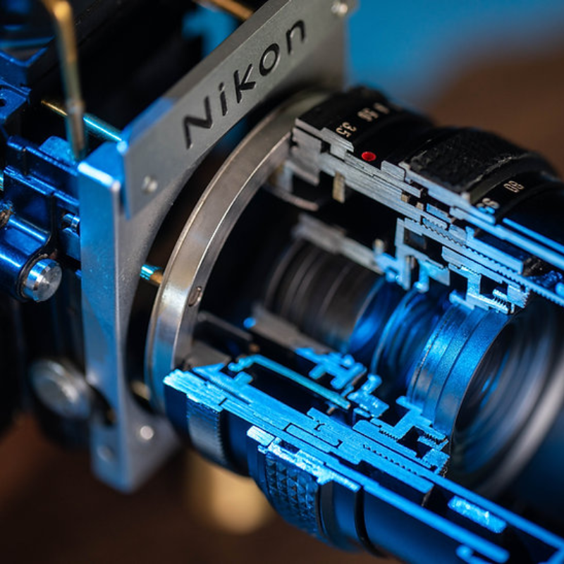 Disassembled Mechanical Film Camera Nikon F With cut lens